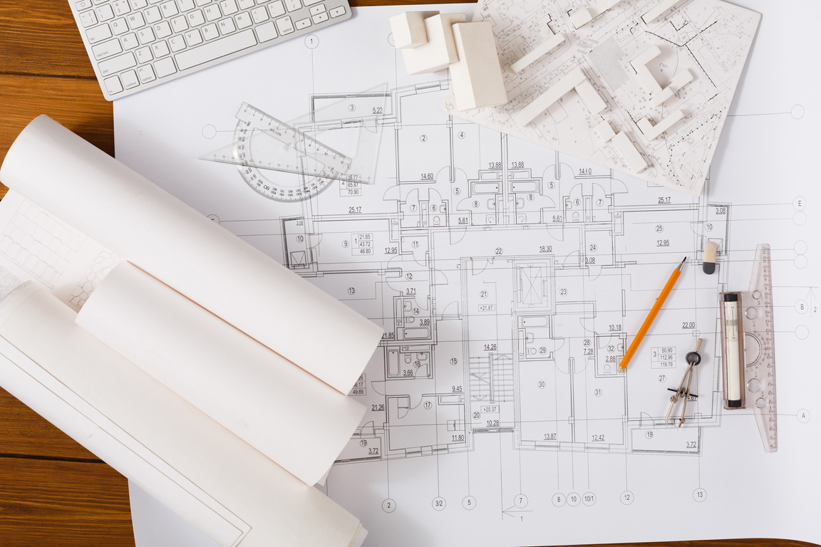 Architectural project, engineering tools on table.